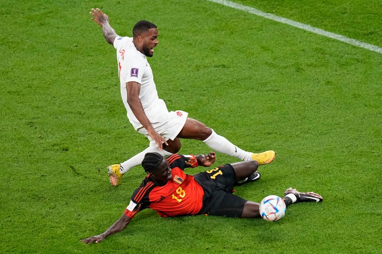 Canada's Cyle Larin and Belgium's Amadou Onana vie for the ball 