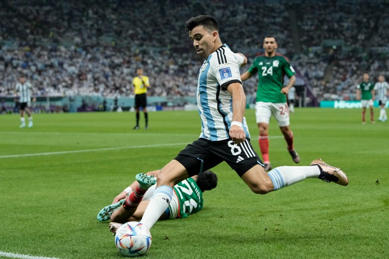 Argentina's Marcos Acuna kicks the ball during the World Cup match between Argentina and Mexico.