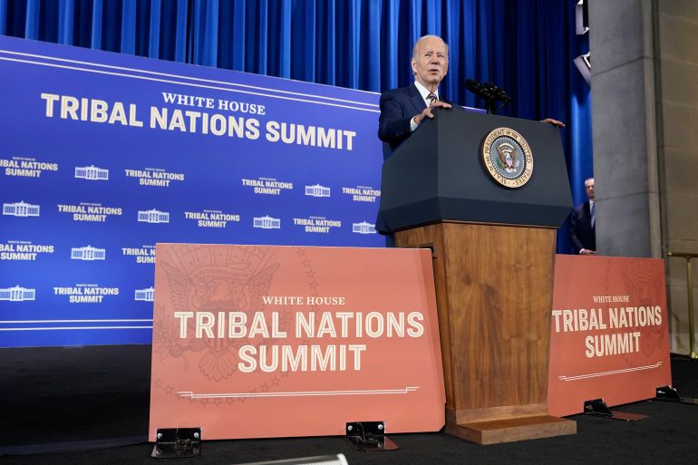 President Joe Biden at a podium surrounded by signs that read "Tribal Nations Summit"