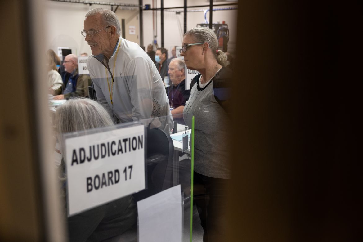 An adjucation board reviews ballots at the Maricopa County Tabulation and Election Center.