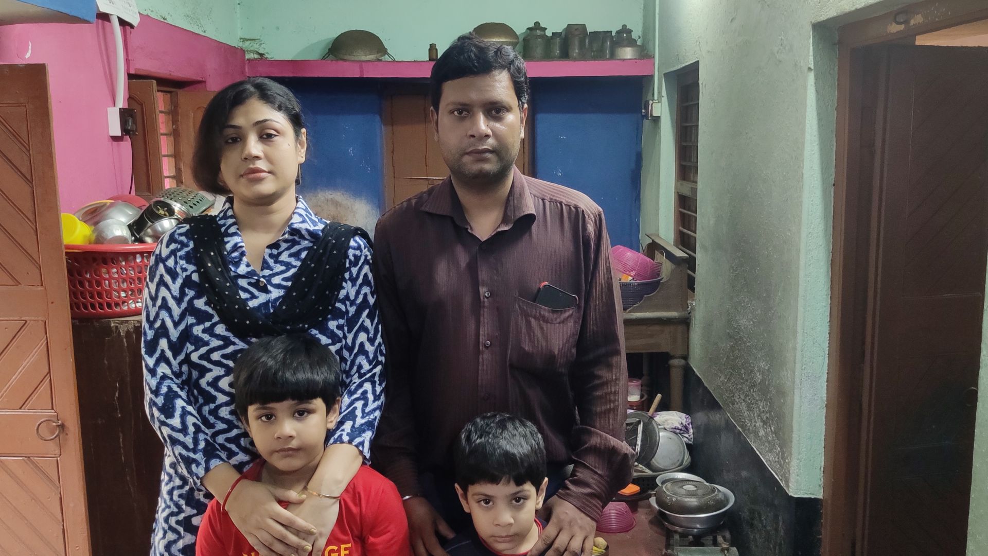 a photo of Arijit Khan, his wife standing next to him (left) and standing in front of them are their two children.