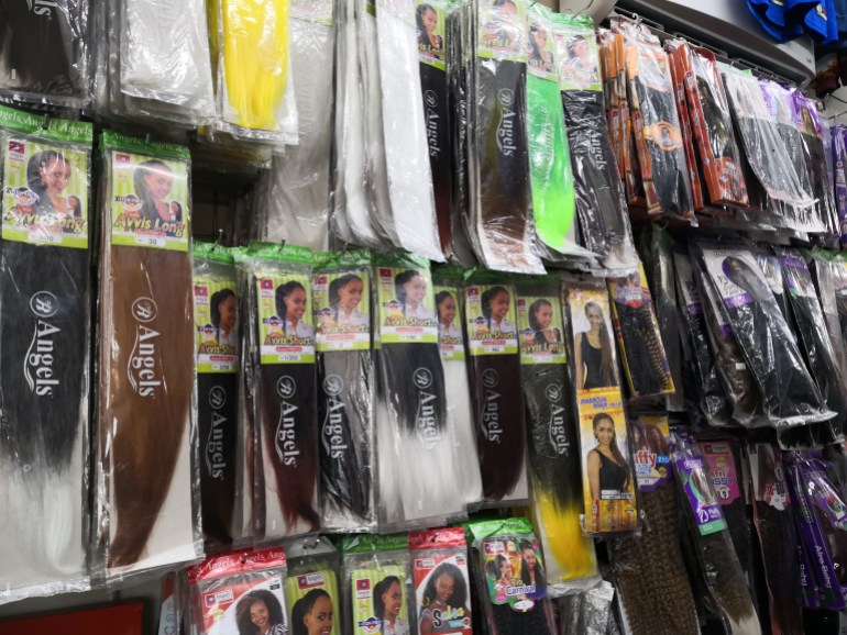A photo of hair extensions being sold in a shop.