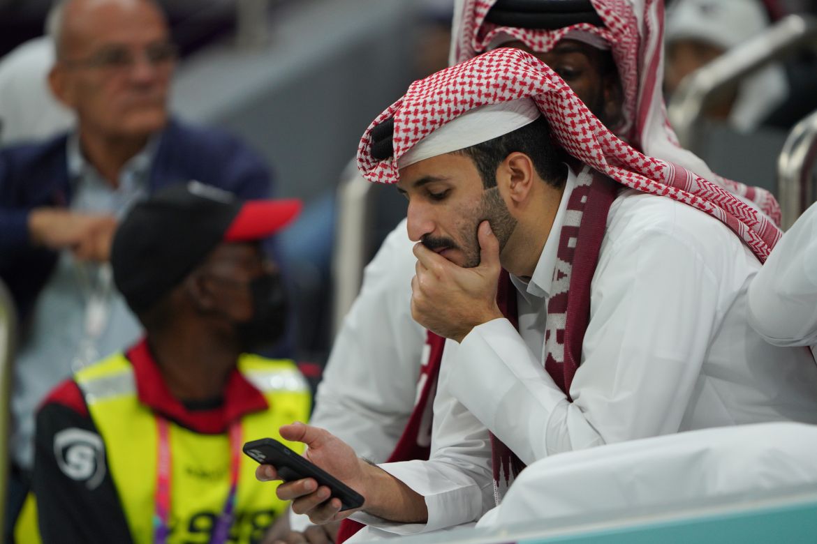 Worried fan looks at mobile phone