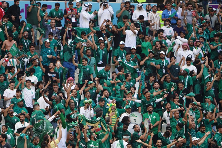 Saudi fans celebrate in the stands after their team score the first goal.