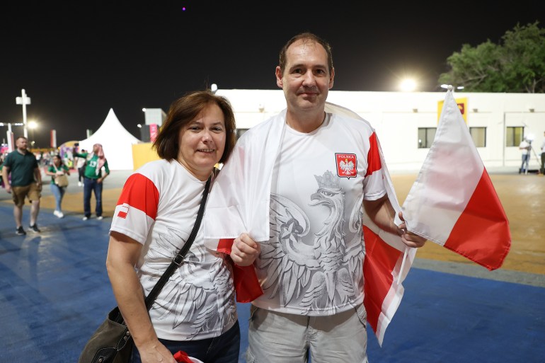 53 year old Polish couple Dariusz and wife Jolanta are Qatar residents and are thrilled to be at the stadium to root for their team. M| exico vs Poland, Group C, FIFA World Cup 2022, November 22, at Stadium 974 in Ras Abu Aboud, Qatar [Showkat Shafi/ Al Jazeera]
