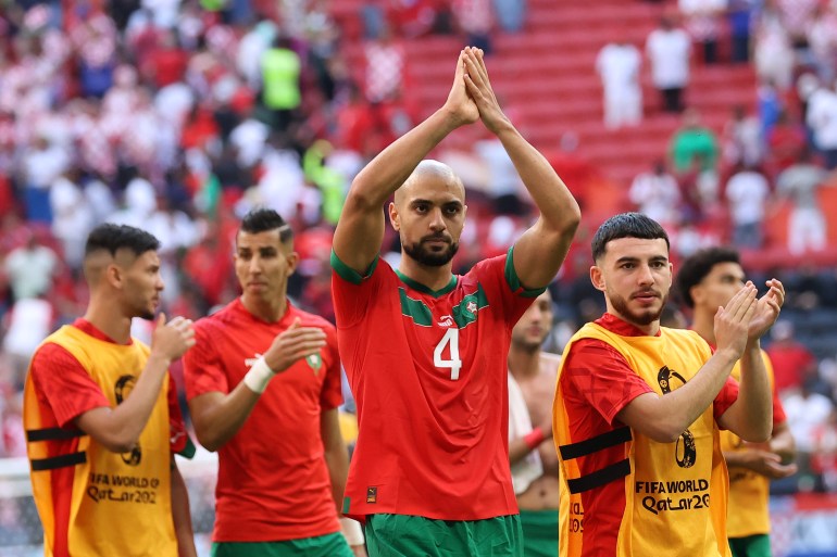 Morocco team members clap after their game against Croatia.
