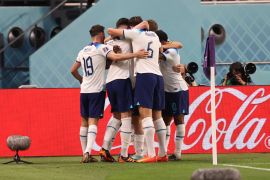 England players huddle in celebration in Doha, Qatar