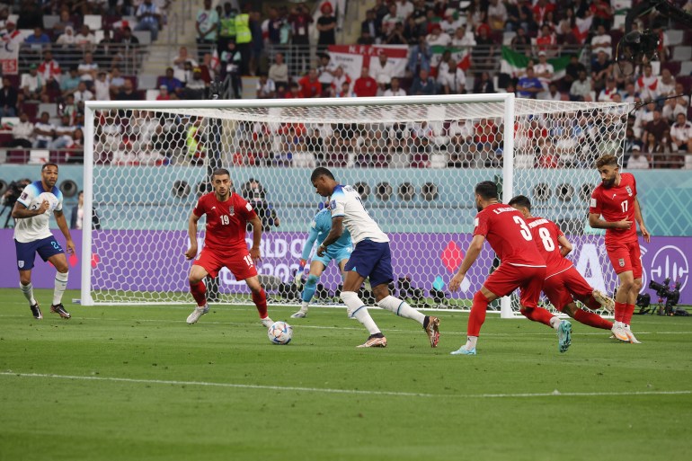 Marcus Rashford, who scored within 49 seconds of coming on as a substitute for England against Iran, dribbles the ball in the penalty area.