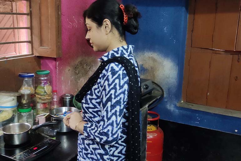 A photo of Arijit Khan's wife cooking on induction oven.
