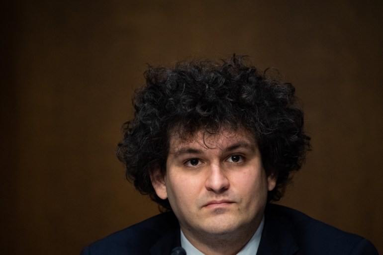  Sam Bankman-Fried with dark, curly hair and looking serious.