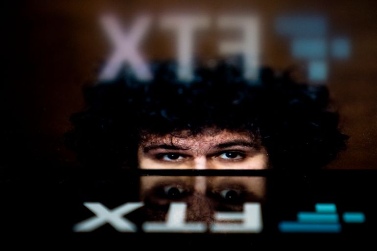 Sam Bankman-Fried's face reflected in the FTX logo.