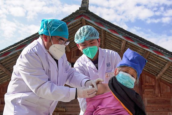 An elderly woman receives a Covid-19 vaccine in Danzhai