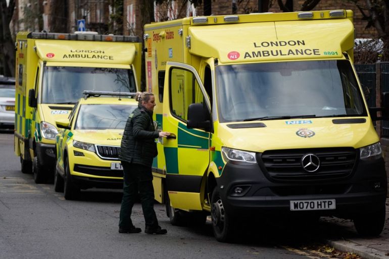 A paramedic shuts the door of an ambulance outside the Waterloo ambulance station in London