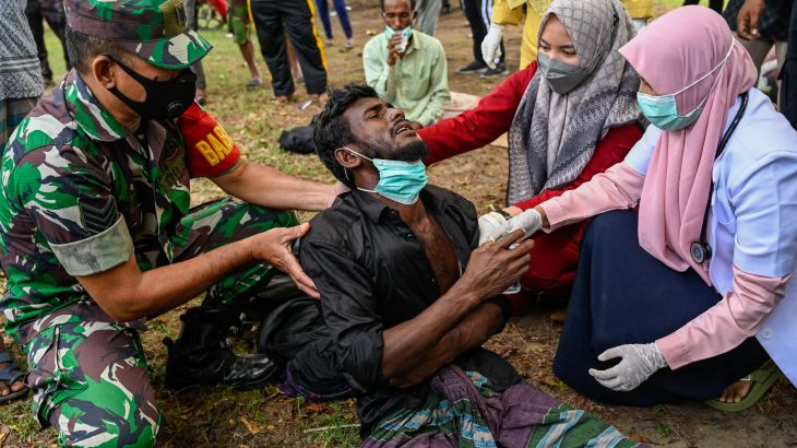 health workers check Rohingya in Indonesia