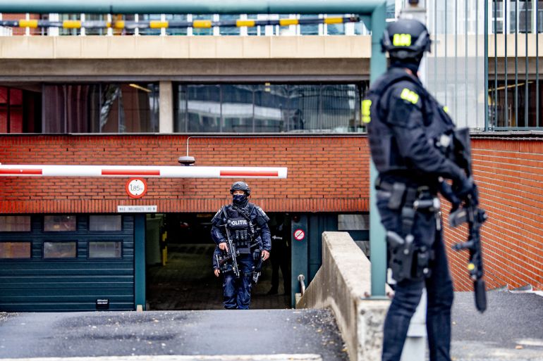 Police officers stand guard as a transport arrives at the extra secure court in Rotterdam, on June 22, 2021, prior to the hearing on the extradition of Tse Chi Lop. - Tse Chi Lop, a Canadian of Chinese origin, was one of the most wanted drug criminals in the world and was arrested in January at Schiphol. (Photo by Robin UTRECHT / ANP / AFP) / Netherlands OUT
