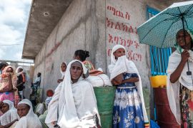Women wait during a food distribution event organised by the Amhara government in the Tigray region of Ethiopia, July 11, 2021