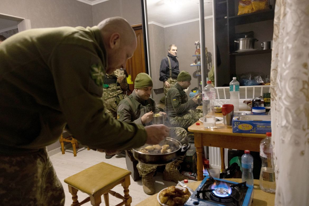 Military medics prepare food at a frontline field hospital