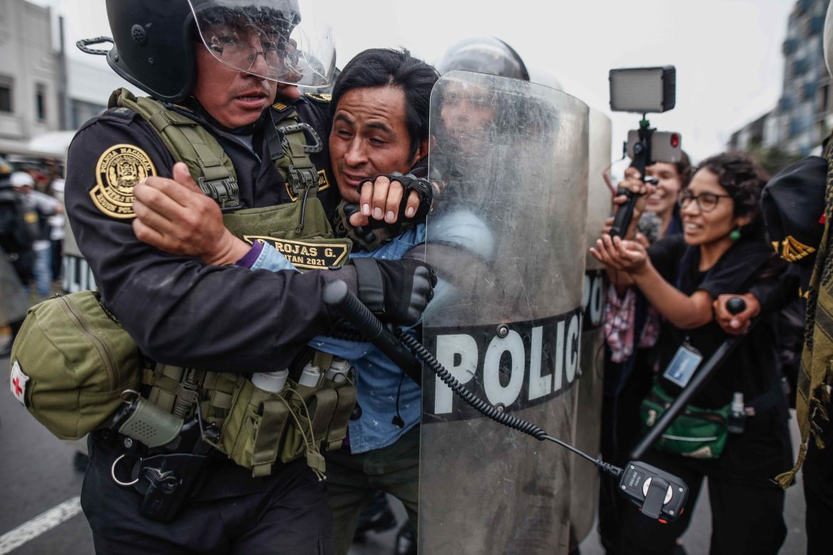 Police detain a man during a confrontation