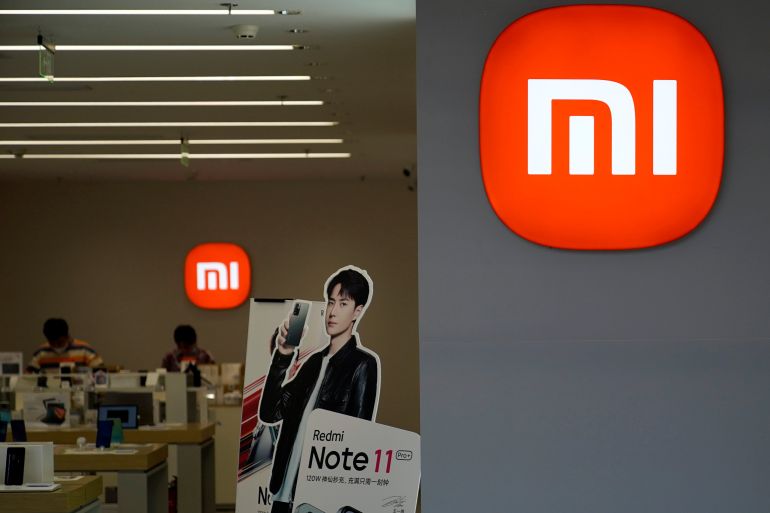 An advertisement for Xiaomi's Redmi Note 11 smartphone stands at a Xiaomi store in Shanghai, China.