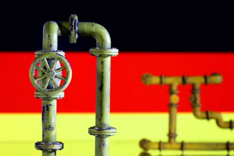 FILE PHOTO: Model of natural gas pipeline and German flag, July 18, 2022. REUTERS/Dado Ruvic/Illustration/File Photo
