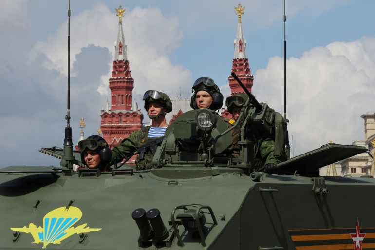 FILE PHOTO: Russian service members are seen atop of an armoured vehicle during a military parade on Victory Day, which marks the 77th anniversary of the victory over Nazi Germany in World War Two, in Red Square in central Moscow, Russia May 9, 2022. REUTERS/Evgenia Novozhenina/File Photo/File Photo