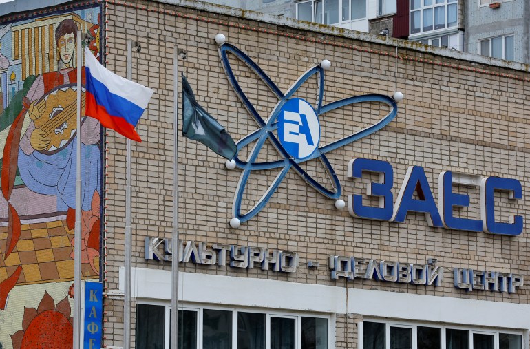 A Russian flag flies near a culture and business centre, with the logo of the Zaporizhzhia Nuclear Power Plant seen on its facade, in the course of Russia-Ukraine conflict in the city of Enerhodar in the Zaporizhzhia region, Russian-controlled Ukraine