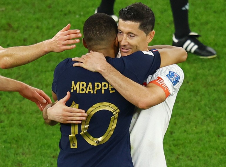 France's Kylian Mbappe and Poland's Robert Lewandowski embrace after the match on December 4, 2022.