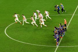 Croatia players celebrate after winning the penalty shootout as Japan players look dejected