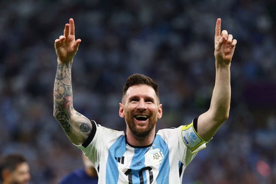 Argentina's Lionel Messi celebrates with arms held high in victory as Argentina progress to the semifinals of the World Cup 2022.