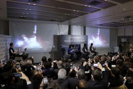 Officials of ispace Inc's HAKUTO-R mission look at live broadcasting of the launch of a SpaceX Falcon 9 rocket for ispace at Cape Canaveral Space Force Station