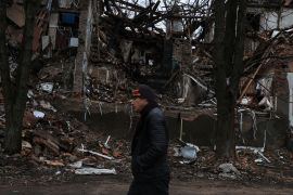A man walks down a war-torn street, as Russia's attack on Ukraine continues, in the city Slovyansk, Donetsk region of Ukraine, December 12, 2022. REUTERS/Shannon Stapleton