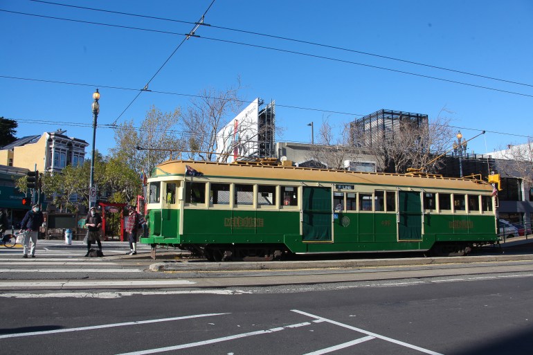 A green 1920s streetcar in San Francisco