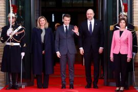 Ukraine's first lady Olena Zelenska, French President Emmanuel Macron, Ukrainian Prime Minister Denys Shmyhal and French Foreign Minister Catherine Colonna pose as they arrive to attend the international conference "Standing With the Ukrainian People" in Paris, France, December 13, 2022. REUTERS/Gonzalo Fuentes