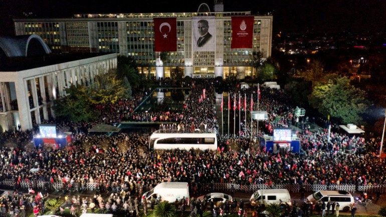 Istanbul Mayor Ekrem Imamoglu addresses his supporters on top of a bus 