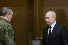 Chief of the Russian General Staff Valery Gerasimov greets Russian President Vladimir Putin during a visit to the joint headquarters of the Russian armed forces.