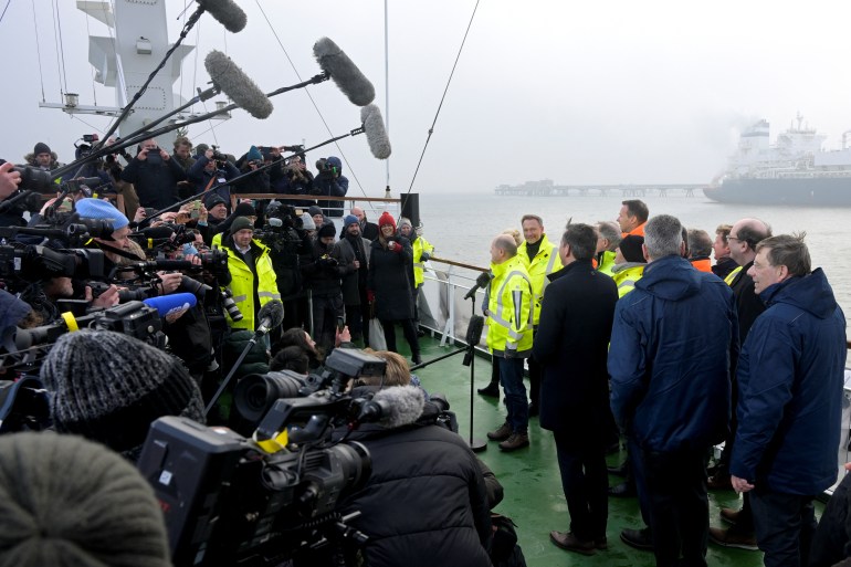 Media members surround German Chancellor Olaf Scholz during the opening of Germany's first LNG Terminal in Wilhelmshaven, Germany, December 17, 2022. REUTERS/Fabian Bimmer