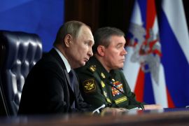 Russian President Vladimir Putin and Chief of the General Staff of Russian Armed Forces Valery Gerasimov attend an annual meeting of the Defence Ministry Board in Moscow