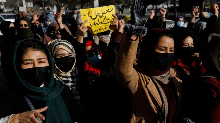 Afghan women chant slogans in protest against the closure of universities