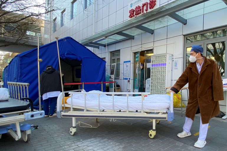 A nurse pushes a bed outside a fever clinic in china
