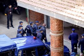Police officers escort Charles Sobhraj, a French national known as 'The Serpent', suspected of killing over 20 Western backpackers across Asia, to the Department of Immigration after he was released from prison, following an order of Nepal's Supreme Court, in Kathmandu, Nepal December 23, 2022