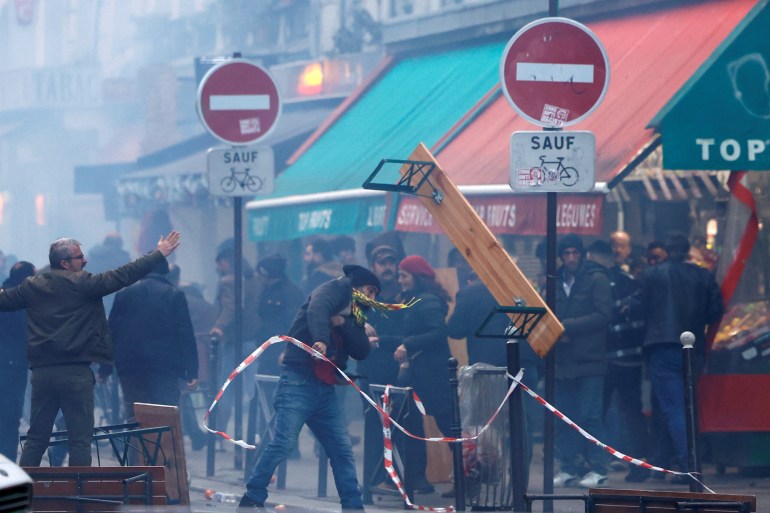 Protestors clash with French police during a demonstration near the Rue d'Enghien