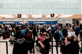Passengers line up at Southwest Airlines kiosk