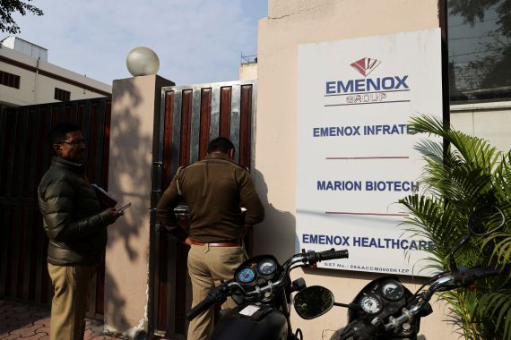 Police at the gate of an office of Marion Biotech, a healthcare and pharmaceutical company, whose cough syrup has been linked to the deaths of children in Uzbekistan, in Noida, India