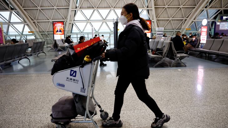 A traveller pushes a luggage cart at Chengdu Shuangliu International Airport