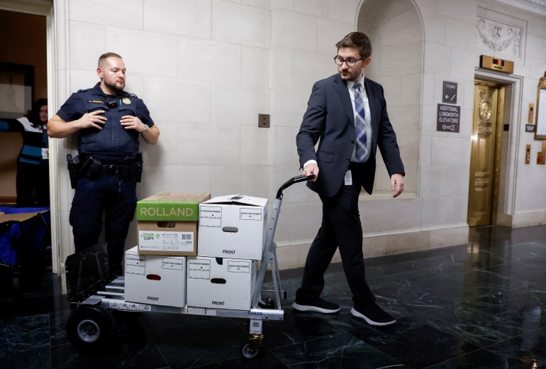 U.S. House Ways and Means Committee staff members transport boxes of documents