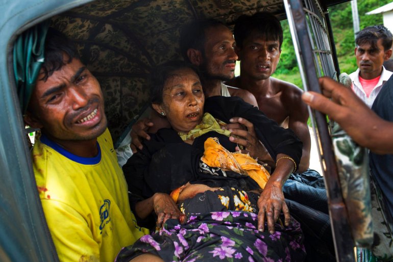 An injured elderly woman and her relatives rush to a hospital on an autorickshaw, near the border town of Kutupalong, Bangladesh, after the Rohingya woman encountered a landmine that blew off her right leg while trying to cross into Bangladesh.
