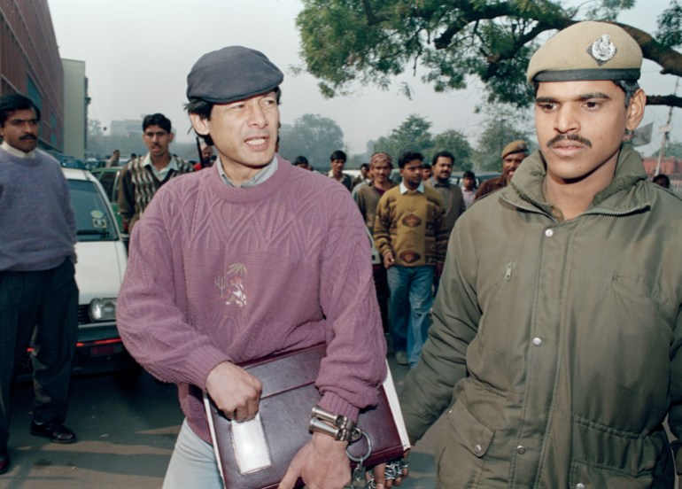 Charles Sobhraj, left, at one time wanted in eight different countries for crimes ranging from car theft to murder, arrives handcuffed by police at a courthouse in New Delhi, India, Jan. 20, 1993. The Vietnamese-born Frenchman, who has been in Indian jails since 1976, is on trial for a jailbreak eight years ago. The judicial process is likely to last beyond a December 1995 deadline, when an extradition request by Thailand on murder charges will expire under a 20-year statute of limitations