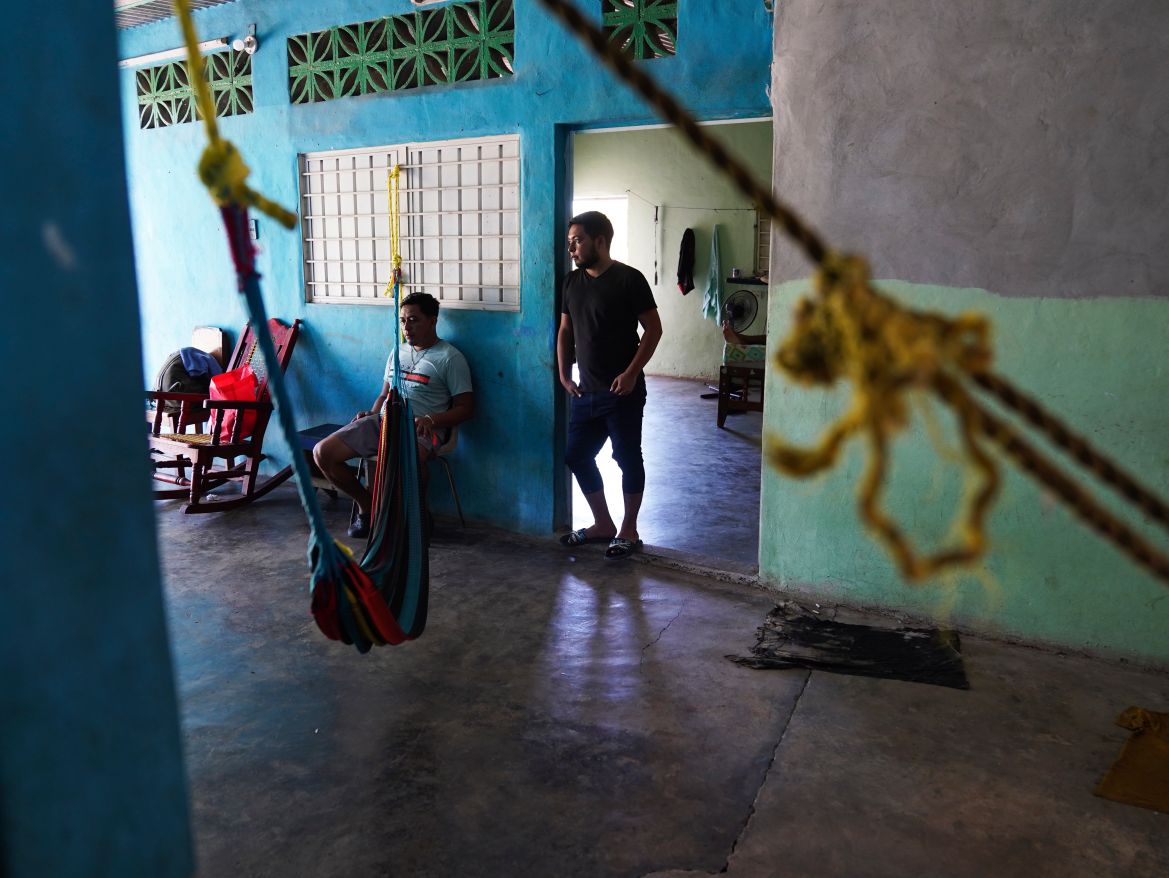 Migrants wait inside a local's home they are paying to stay in while waiting on the Mexican immigration office