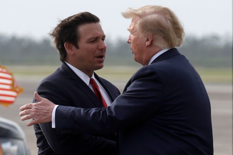 FILE - President Donald Trump shakes hands with Florida Gov. Ron DeSantis as he arrives at Tyndall Air Force Base to view damage from Hurricane Michael, and attend a political rally, May 8, 2019, at Tyndall Air Force Base, Fla. (AP Photo/Evan Vucci, File)