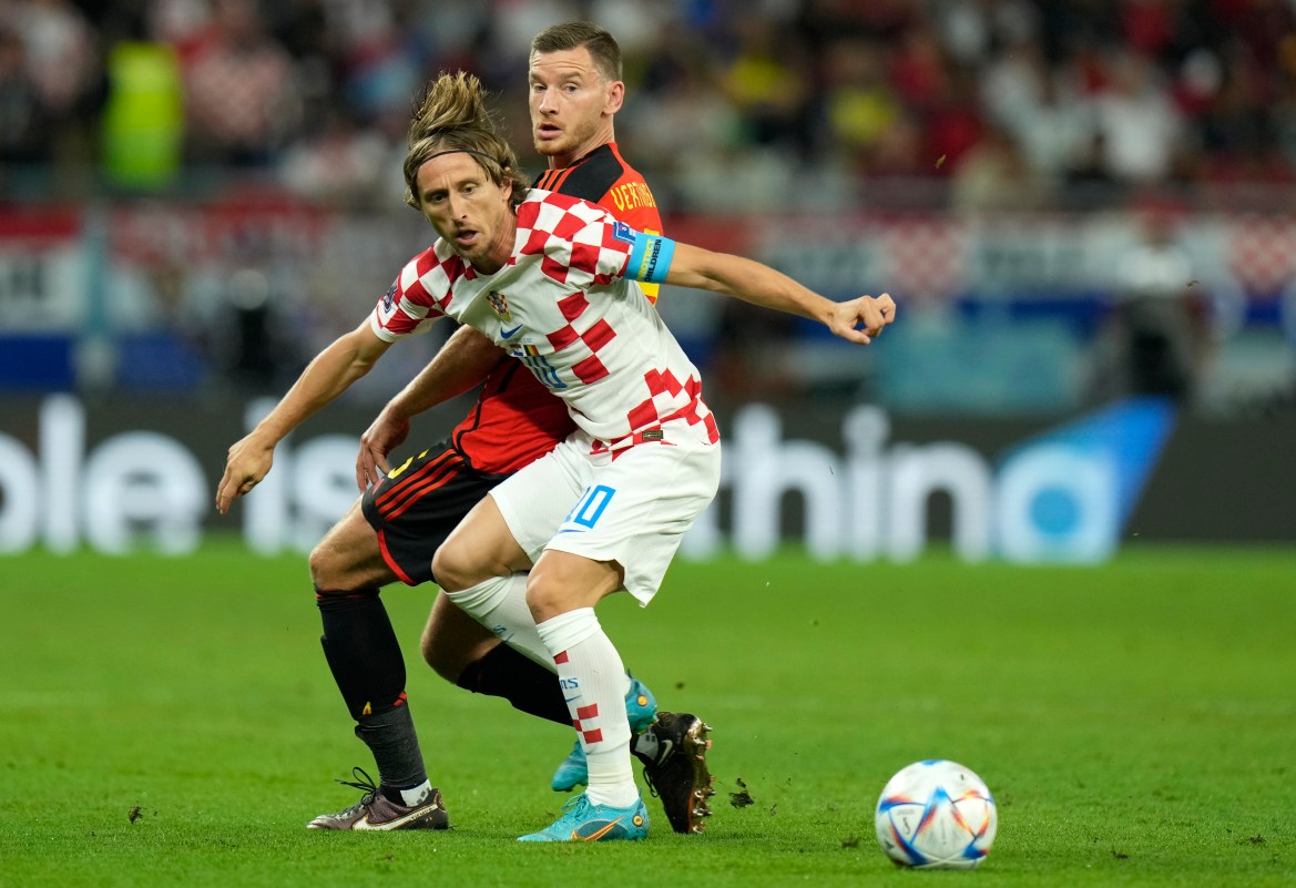 Croatia's Luka Modric, front, duels for the ball with Belgium's Jan Vertonghen